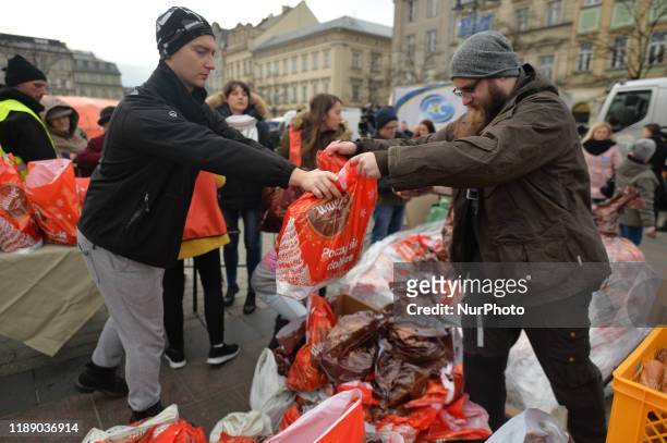 Volunteers preparing plastic bags with Christmas Goodies during the 2019 Edition of 'Christmas Eve - Christmas Food Handout' for homeless and people...