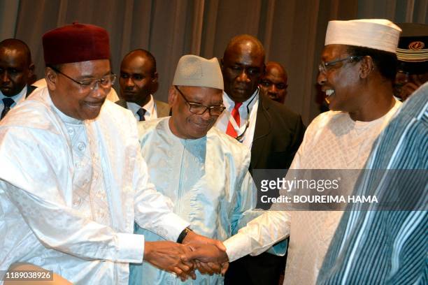 Niger's President Mahamadou Issoufou , Mali's President Ibrahim Boubacar Keita and Tchad's President Idriss Deby shake hands at the G5 Sahel summit...