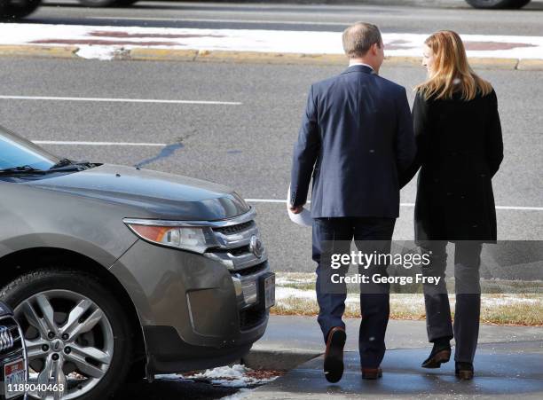 Rep. Ben McAdams and his wife Julie, , walk to their car after the congressman announced he will vote yes on both articles of Impeachment of...