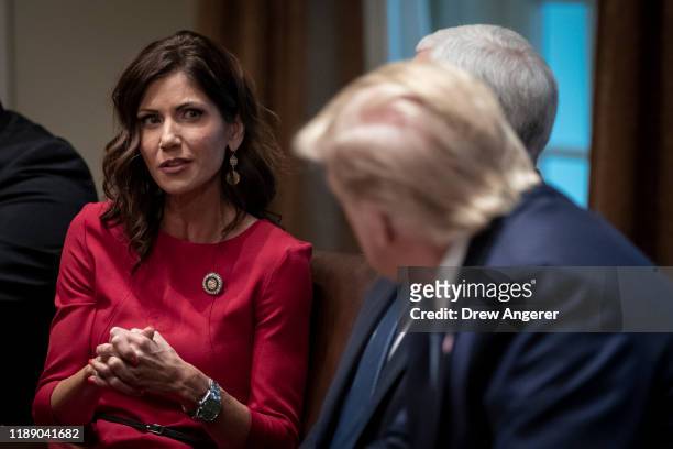 Governor of South Dakota Kristi Noem speaks as U.S. President Donald Trump listens during a meeting about the Governors Initiative on Regulatory...