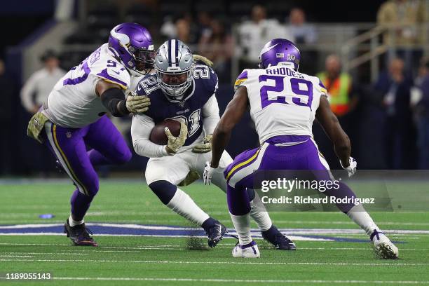 Everson Griffen and Xavier Rhodes of the Minnesota Vikings try to stop Ezekiel Elliott of the Dallas Cowboys at AT&T Stadium on November 10, 2019 in...