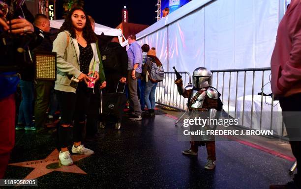 Star Wars fans, some dressed in costume, hang around outside the world premiere of Disney's "Star Wars: Rise of Skywalker" at the TCL Chinese Theatre...