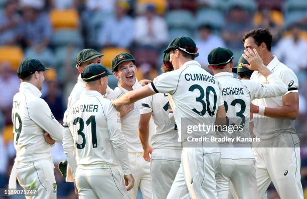 Tim Paine of Australia celebrates with his team mates after dismissing Shaheen Shah Afridi of Pakistan during day one of the 1st Domain Test between...