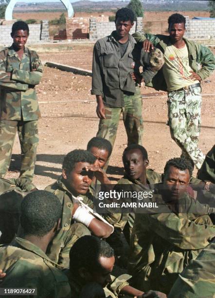 Eritrean soldiers stand guard in front of Ethiopian prisoners 14 Febuary at a camp outside Asmara. Fighting between Eritrea and Ethiopia spread 14...