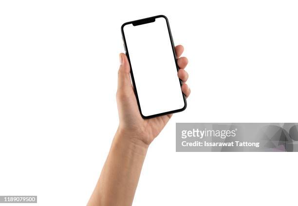 close up hand hold phone isolated on white, mock-up smartphone white color blank screen - smartphone stock-fotos und bilder