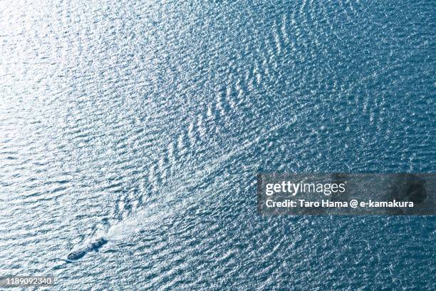 cargo container sailing on tokyo bay in japan aerial view from airplane - tokyo bay fotografías e imágenes de stock