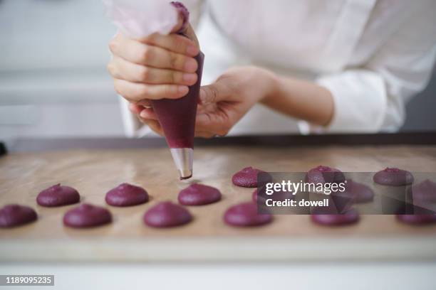 young asian woman using icing bag  in bakery - macaroon stock pictures, royalty-free photos & images