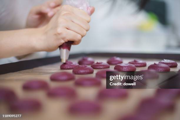 young asian woman using icing bag in bakery - icing bag stock pictures, royalty-free photos & images