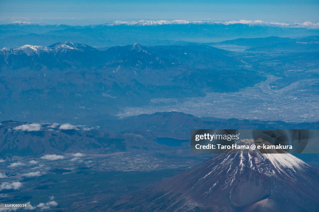 Snow-capped Mt. Fuji and Hida Mountains in Japan aerial view from airplane