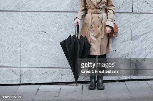 A Woman In Trench Coat Holding Umbrella High-Res Stock Photo - Getty Images