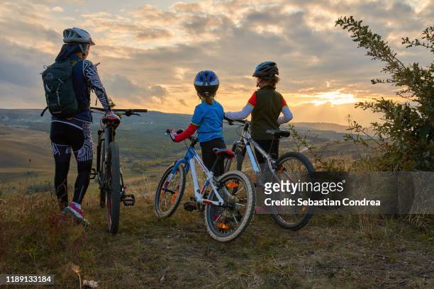 happy mountain bike family,  outdoors have fun together on a summer afternoon sunset, cycling girls activity - beautiful romanian women stock pictures, royalty-free photos & images