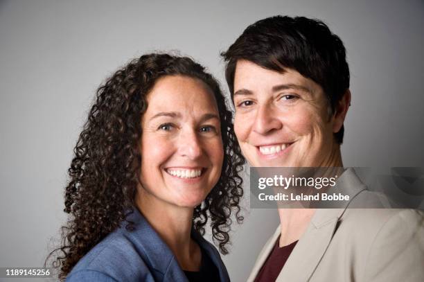 studio portrait of female same sex couple - couples studio portrait stock pictures, royalty-free photos & images