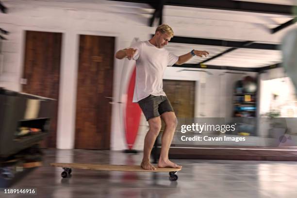 young man riding skateboard - figure skater stockfoto's en -beelden