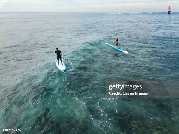 aerial view of sup surfers - sanur stock pictures, royalty-free photos & images