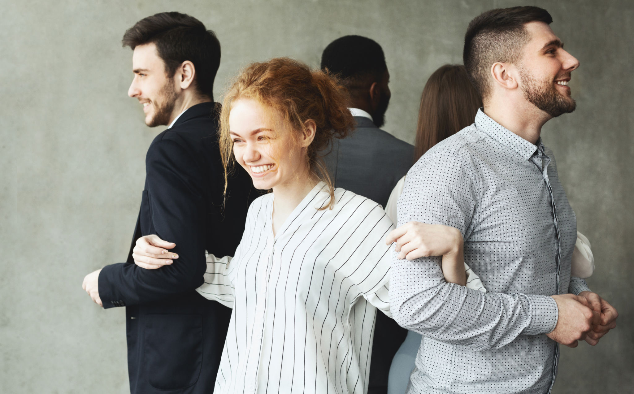Business team standing in circle back to back Business team standing in circle back to back