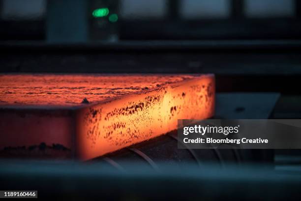 hot steel in a steel factory - iron roll stockfoto's en -beelden