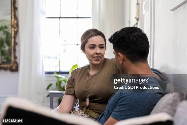 mid adult man and soldier wife have serious talk - military spouse stock pictures, royalty-free photos & images