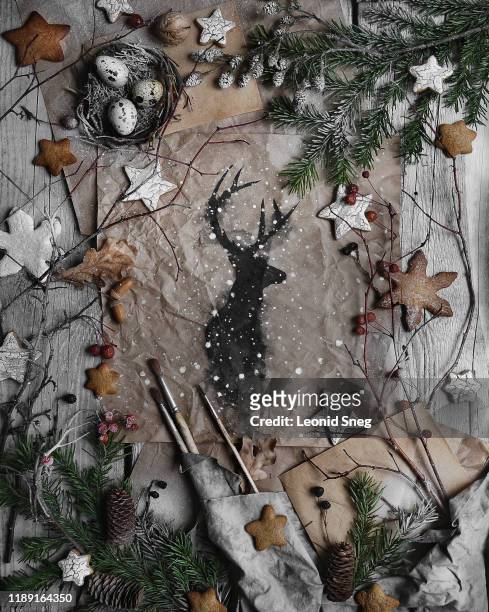 christmas layout flatlay of symbols and decorations on vintage textured paper with a hand-drawn deer with art elements - christmas toys wooden background foto e immagini stock