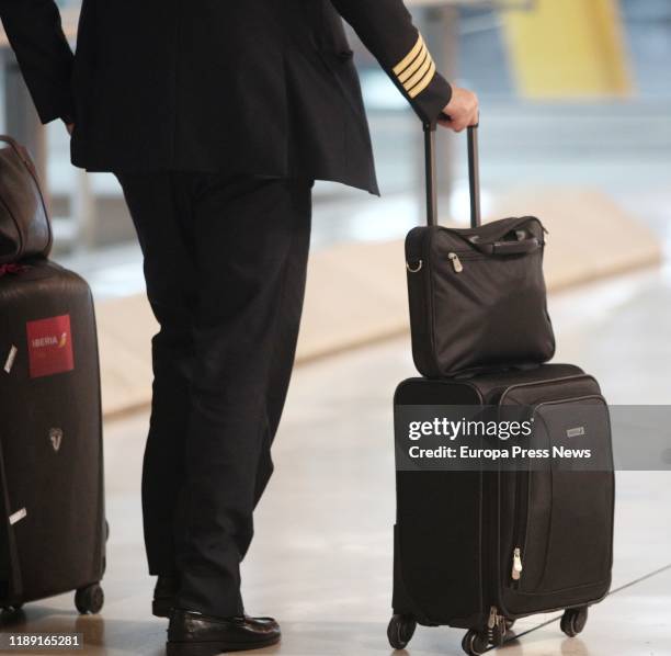 Member of an airline crew is walking with his suitcases at the Adolfo Suarez Madrid-Barajas Airport on November 21, 2019 in Madrid, Spain.