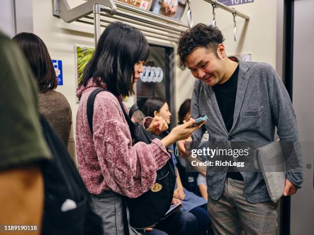 drukke japanse metro trein - crowded train station smartphone stockfoto's en -beelden