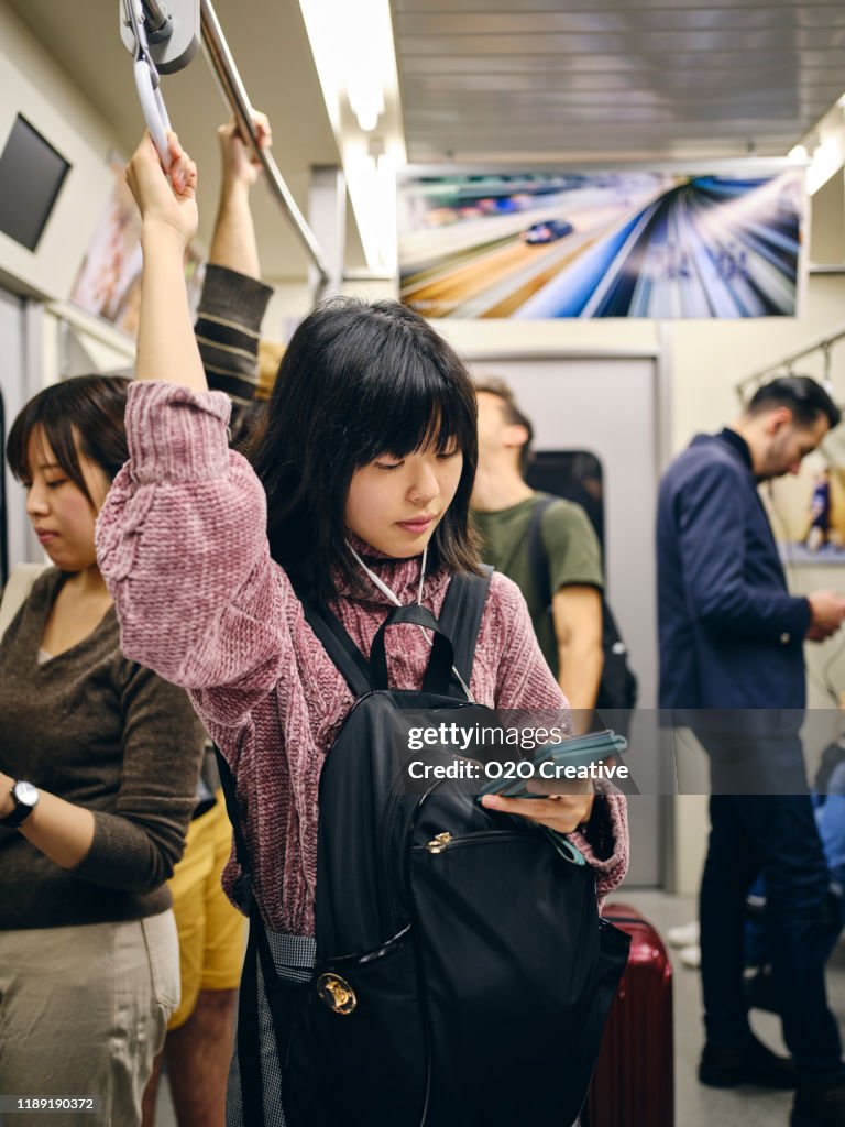 Young Woman on a Crowded Japanese Subway Train