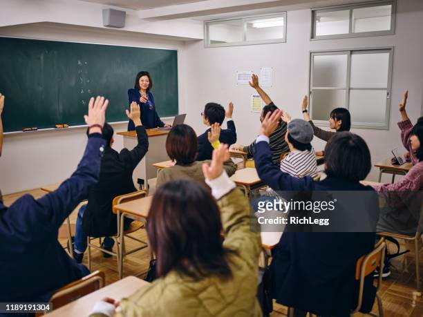 group of adult students in a japanese classroom - japanese people lesson english stock pictures, royalty-free photos & images