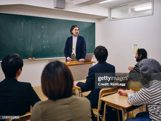 group of adult students in a japanese classroom - japanese people lesson english stock pictures, royalty-free photos & images