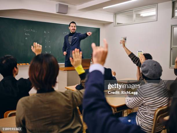 group of adult students in a japanese classroom - japanese people lesson english stock pictures, royalty-free photos & images