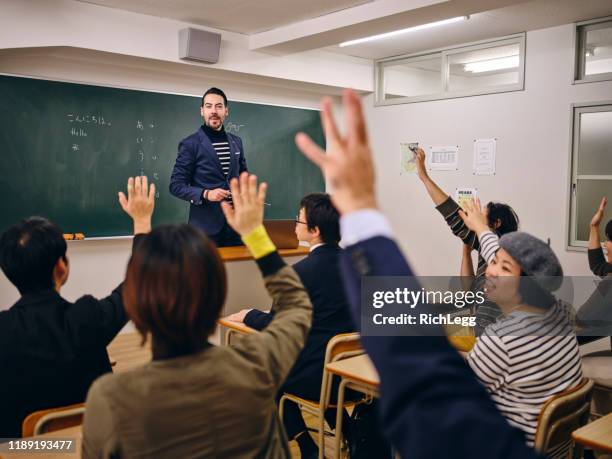 group of adult students in a japanese classroom - english language stock pictures, royalty-free photos & images