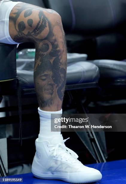 Detailed view of tattoos and the Converse All Stars basketball shoes worn by Kelly Oubre Jr. #3 of the Phoenix Suns against the Sacramento Kings...