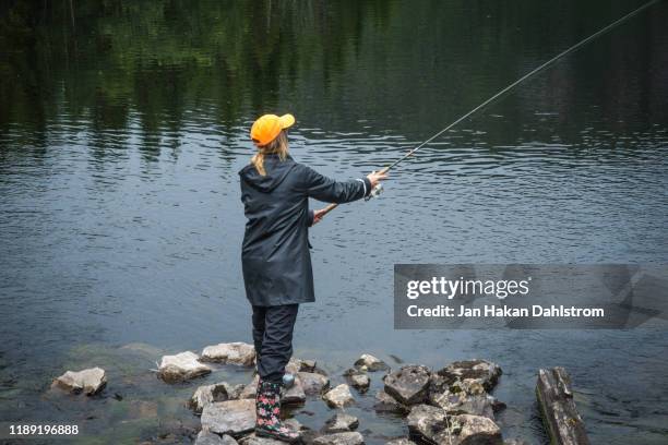 Children With A Fishing Rod On The Lake A Boy And A Girl Are