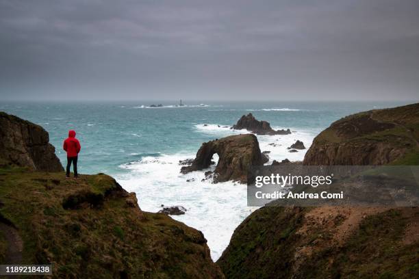 one person looking at view at lands end, england - land's end ストックフォトと画像