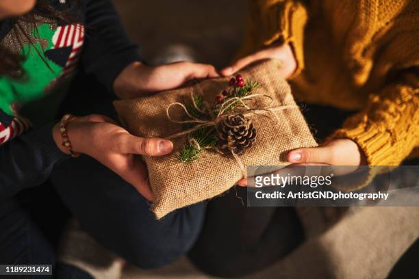 exchanging christmas presents. - christmas gift exchange stock pictures, royalty-free photos & images