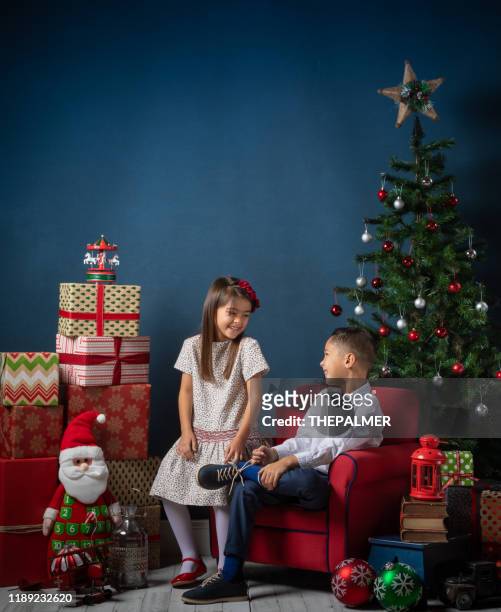 hispanic brother and sister christmas time - sibling christmas stock pictures, royalty-free photos & images
