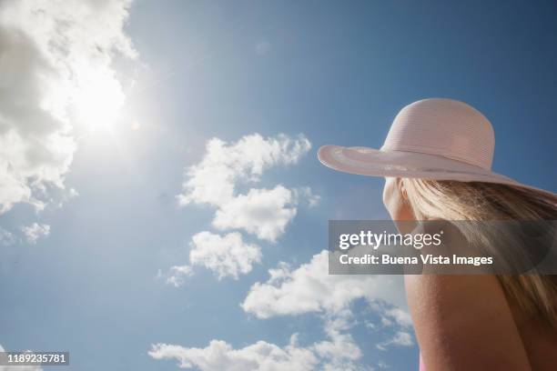 woman watching the sky - vista posterior stock-fotos und bilder