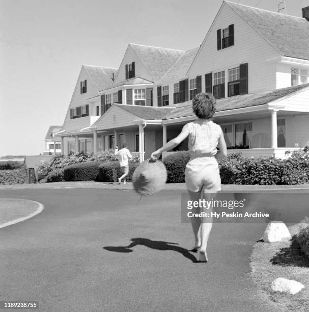 Senator John F. Kennedy and fiance Jacqueline Bouvier run towards the house while on vacation at the Kennedy compound in June, 1953 in Hyannis Port,...