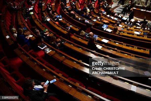 Empty seats of MPs are seen during a session of questions to the government at the National Assembly in Paris on December 17, 2019.