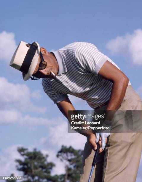 Puerto Rican golfer Chi Chi Rodriguez smoking and putting, circa 1966.