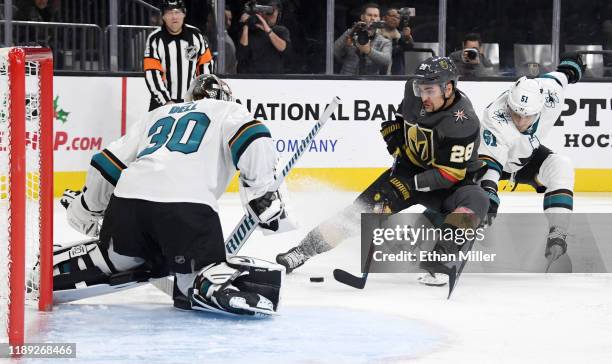 Aaron Dell of the San Jose Sharks makes a save against William Carrier of the Vegas Golden Knights as Radim Simek of the Sharks defends in the second...