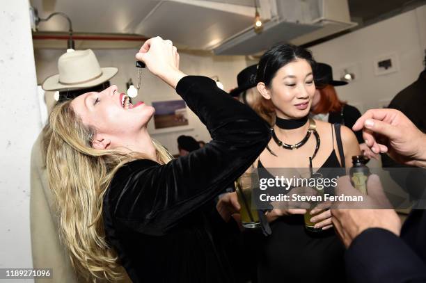 Sabrina Wirth samples Gnome Serum CBD oil at Larry Niehues book launch & photography exhibition at Etiquette on November 21, 2019 in Brooklyn, New...