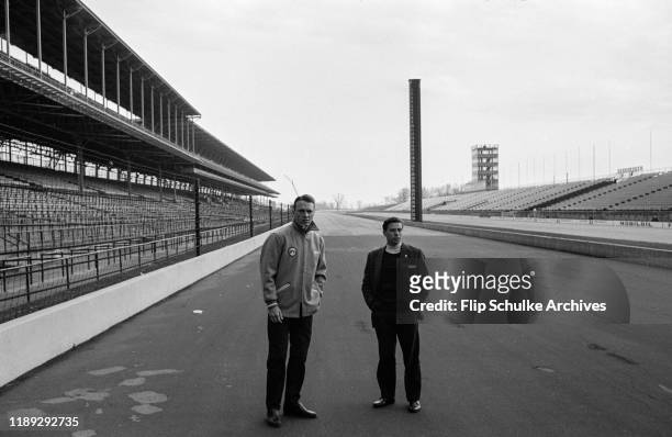American racer Dan Gurney, left, and Scottish motor racing driver Jim Clark surveying the track during the first testing of the Lotus-Ford racecar at...