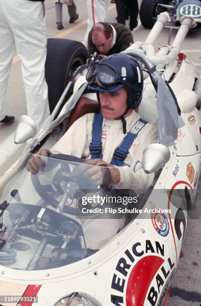 Photograph of English motor racing driver Graham Hill, winner of the 1966 Indy 500 race, seated in the cockpit of his race car, May 30, 1966.