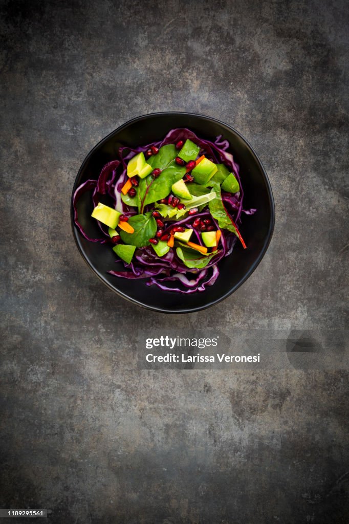 Salad with red cabbage, avocado and pomegranate seeds