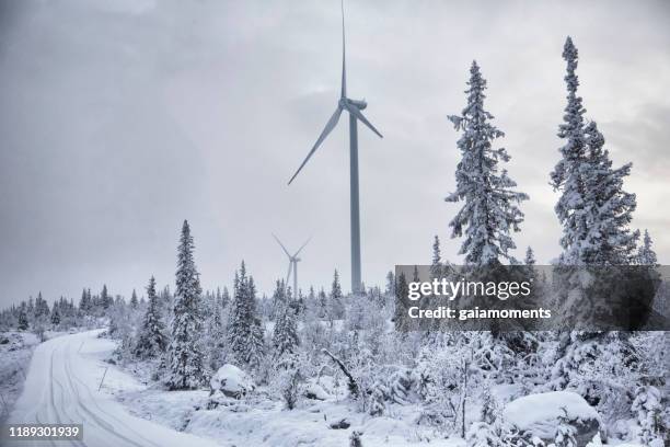 wind turbine in winter landscape - sweden winter stock pictures, royalty-free photos & images