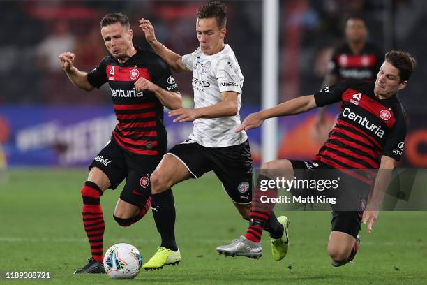 Denis Genreau of Melbourne City FC is tackled by Nicolai Muller and Pirmin Schwegler of the Wanderers during the round 7 A-League match between the...