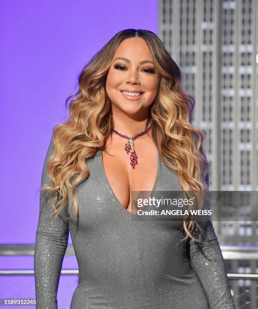 Singer Mariah Carey participates in the ceremonial lighting of the Empire State Building in celebration of the 25th anniversary of "All I Want For...