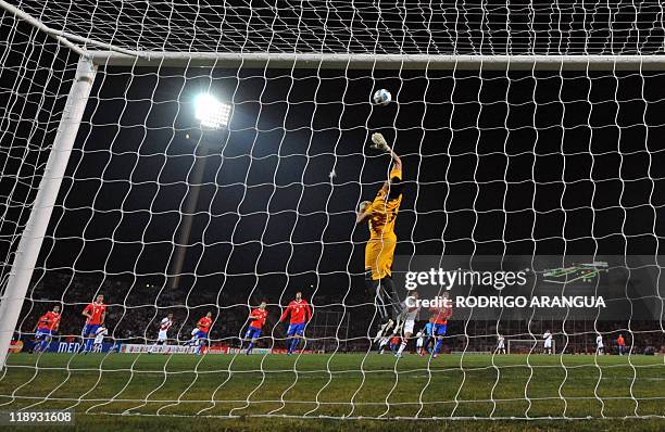 Chilean goalkeeper Miguel Pinto jumps to clear a ball, during a 2011 Copa America Group C first round football match against Peru, at the Malvinas...