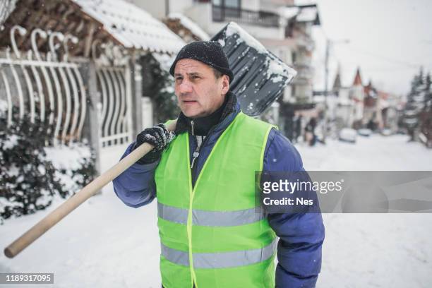 an elderly man was clearing snow - snow removal stock pictures, royalty-free photos & images
