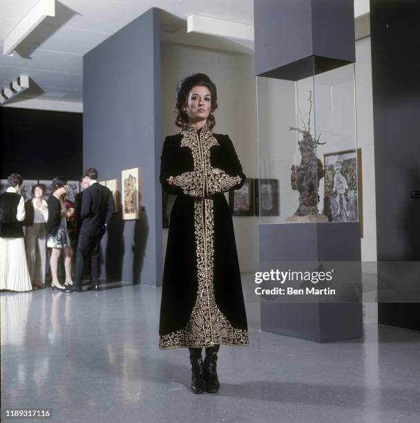 Marisol, painter and sculptor at MoMA wearing a velvet dress coat by Deanna Littell, 1968.