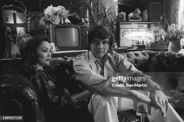 Photographer David Bailey and wife, model Marie Helvin, at home in London, August 18th, 1977.